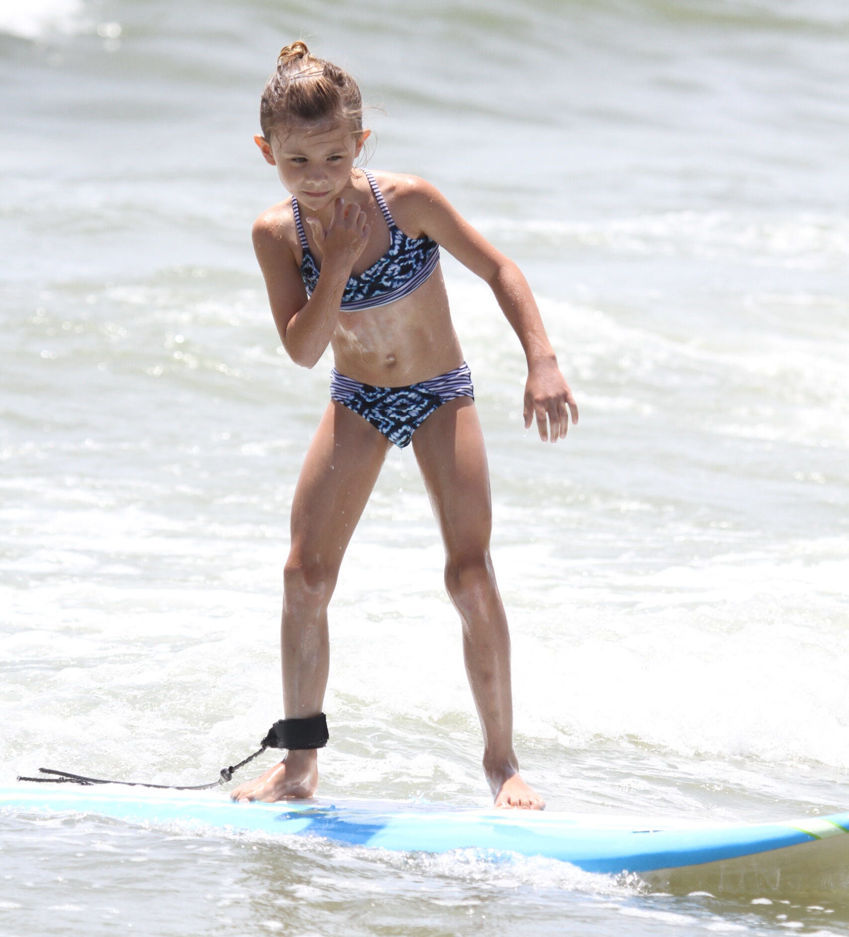 girl surfing in surf camp