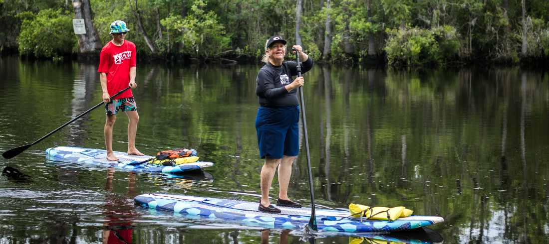 woman enjoys myrtle beach stand up paddleboarding