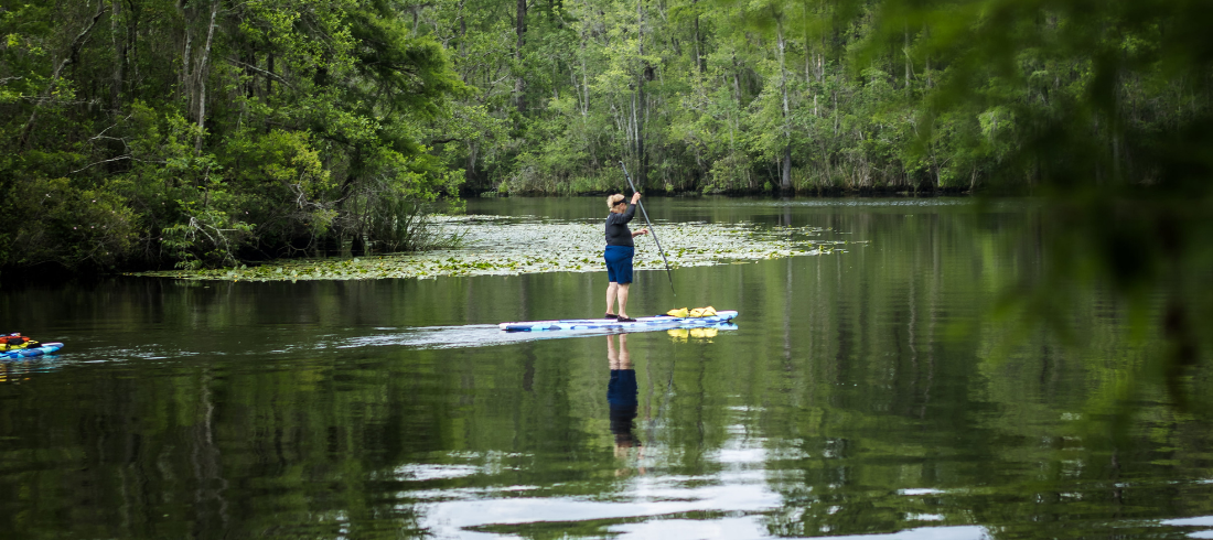 woman enjoys stand up paddleboarding in south carolina