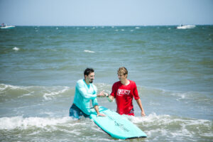 myrtle-beach-surf-lessons-two-people instructor and participant in myrtle beach surf lesson