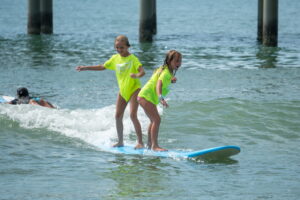 myrtle-beach-surf-school-gallery-10 Participants catching small waves during a Myrtle Beach surf class