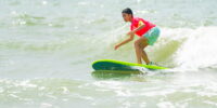 Beginner surfer practicing in a Myrtle Beach surf school class