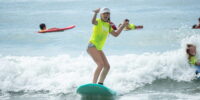 Student learning to surf during a Myrtle Beach surf school lesson